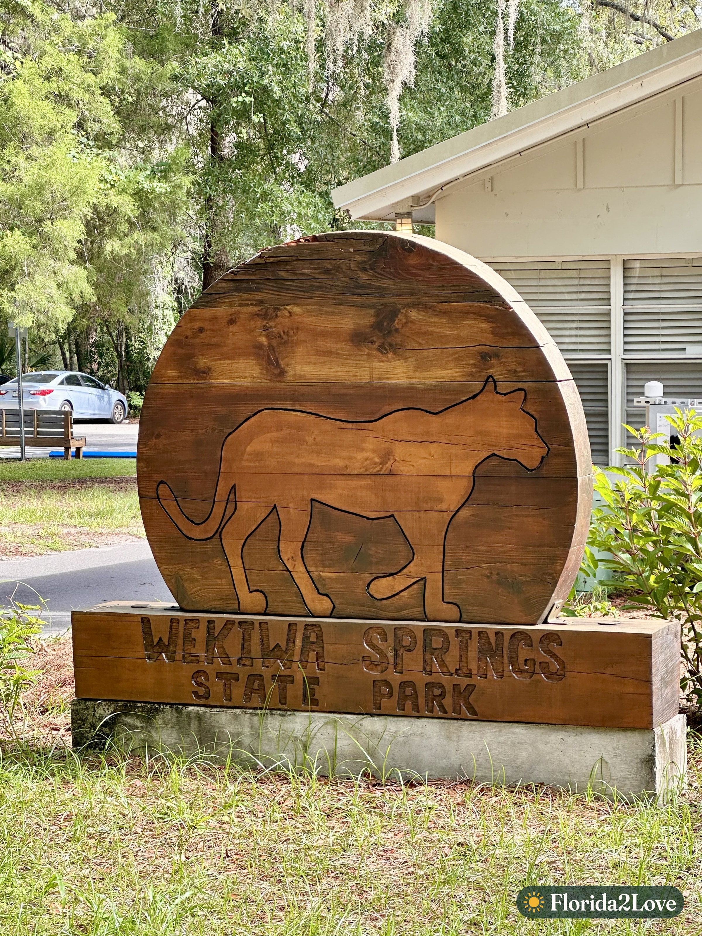 The wooden Wekiwa Springs State Park entrance sign
